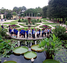 Group of people next to a pond. Links to Gifts of Appreciated Securities